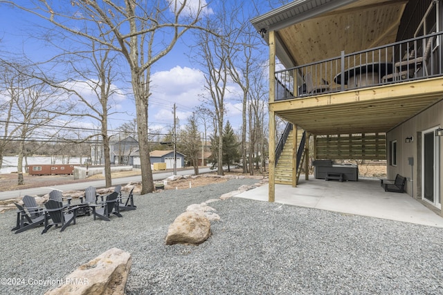 view of yard with an outdoor fire pit, a patio, and stairs