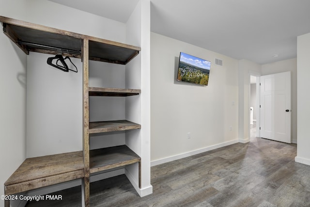 interior space with visible vents, baseboards, and wood finished floors