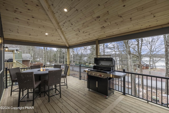 sunroom featuring lofted ceiling with beams, plenty of natural light, and wood ceiling