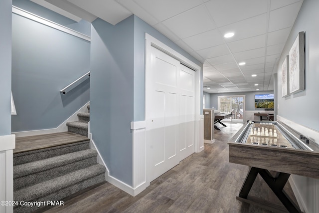 rec room with a paneled ceiling, recessed lighting, baseboards, and wood finished floors