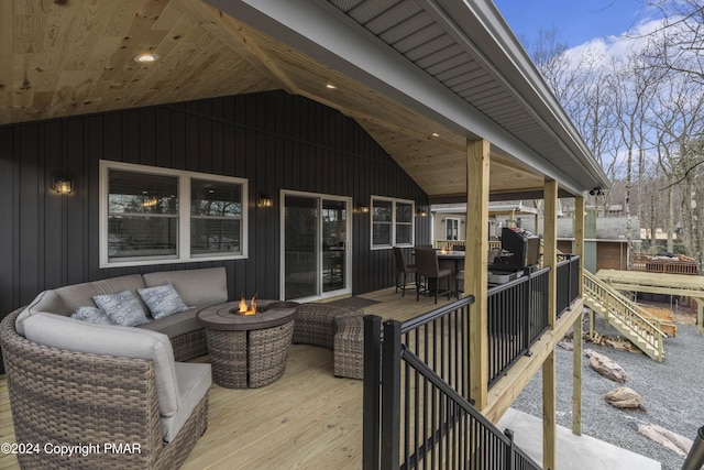 wooden deck with an outdoor living space with a fire pit