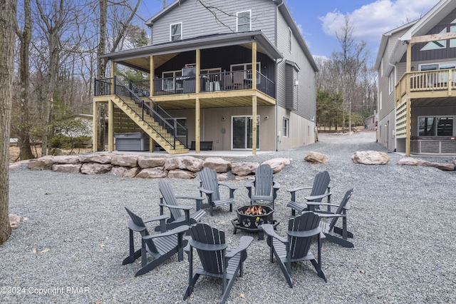 back of house featuring a deck, a patio, an outdoor fire pit, and stairway