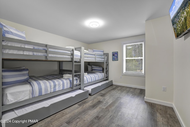 bedroom featuring wood finished floors and baseboards