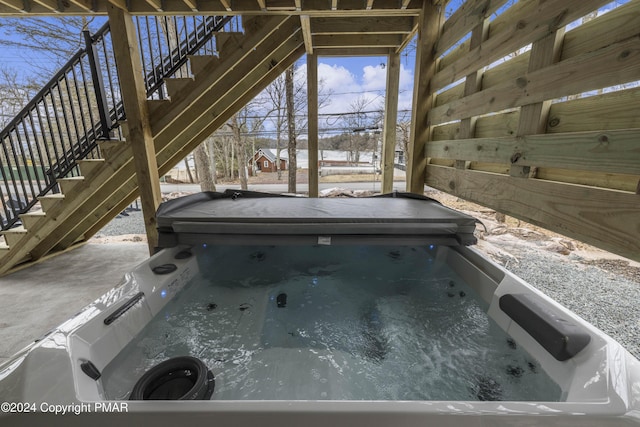 exterior space featuring stairway and a hot tub