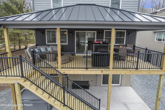 exterior space with metal roof, a standing seam roof, stairs, and an outdoor living space