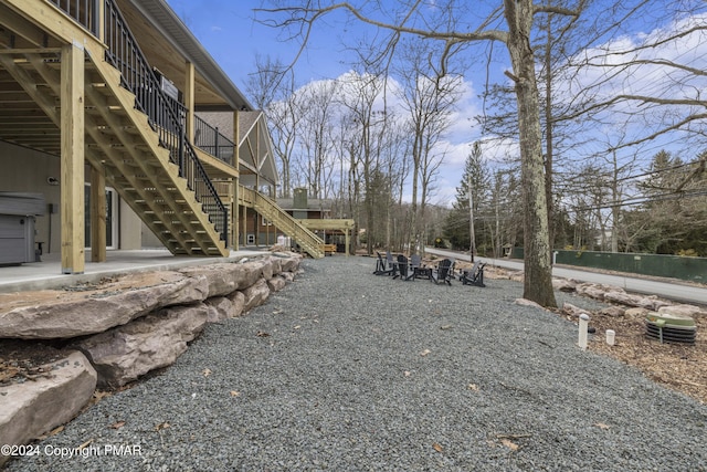 view of yard with a patio area and stairs