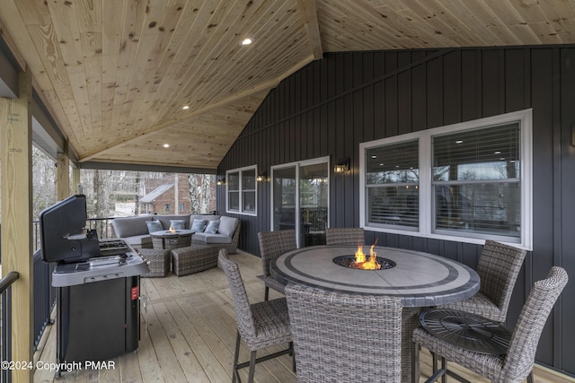 wooden terrace featuring an outdoor living space with a fire pit