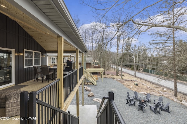 deck with an outdoor fire pit and outdoor dining space