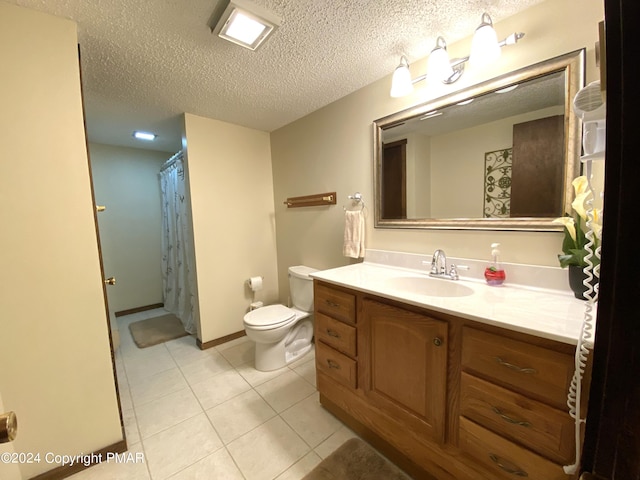 bathroom featuring toilet, tile patterned floors, curtained shower, a textured ceiling, and vanity