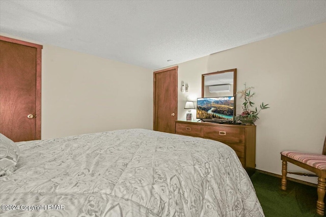 bedroom with carpet flooring and a textured ceiling