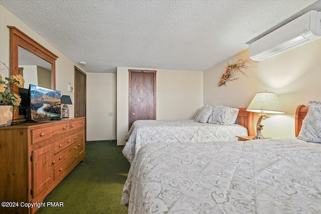 bedroom with a textured ceiling, dark carpet, and a wall mounted air conditioner