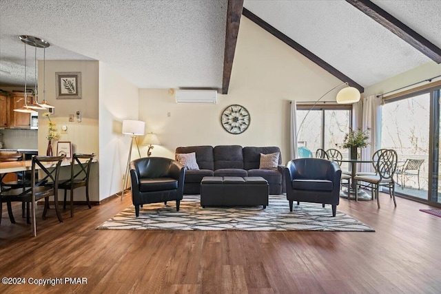 living area with an AC wall unit, a textured ceiling, wood finished floors, high vaulted ceiling, and beamed ceiling