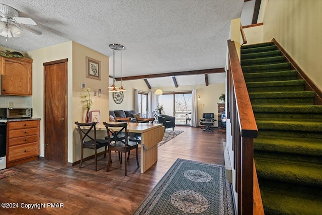 dining area featuring lofted ceiling with beams, ceiling fan, stairway, dark wood-type flooring, and a textured ceiling