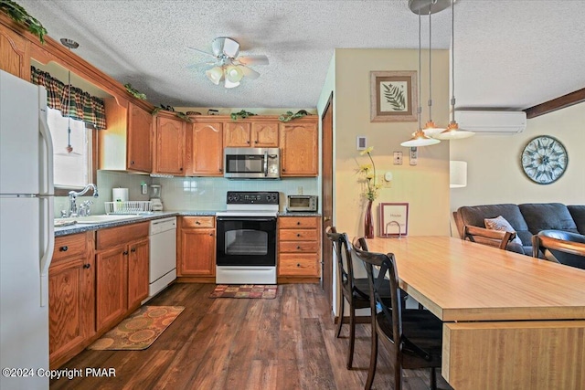 kitchen featuring dark wood-style flooring, backsplash, a sink, white appliances, and a wall mounted air conditioner