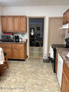 kitchen featuring brown cabinetry, white dishwasher, black / electric stove, a paneled ceiling, and under cabinet range hood