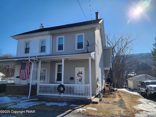 view of front of home featuring a porch and a chimney