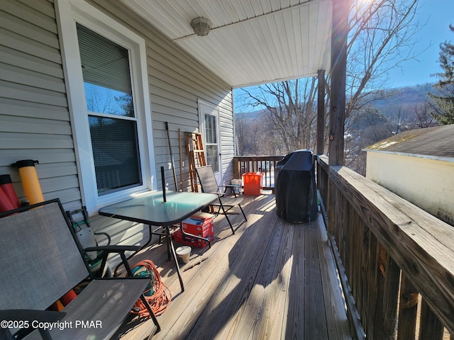 deck featuring a grill and a mountain view