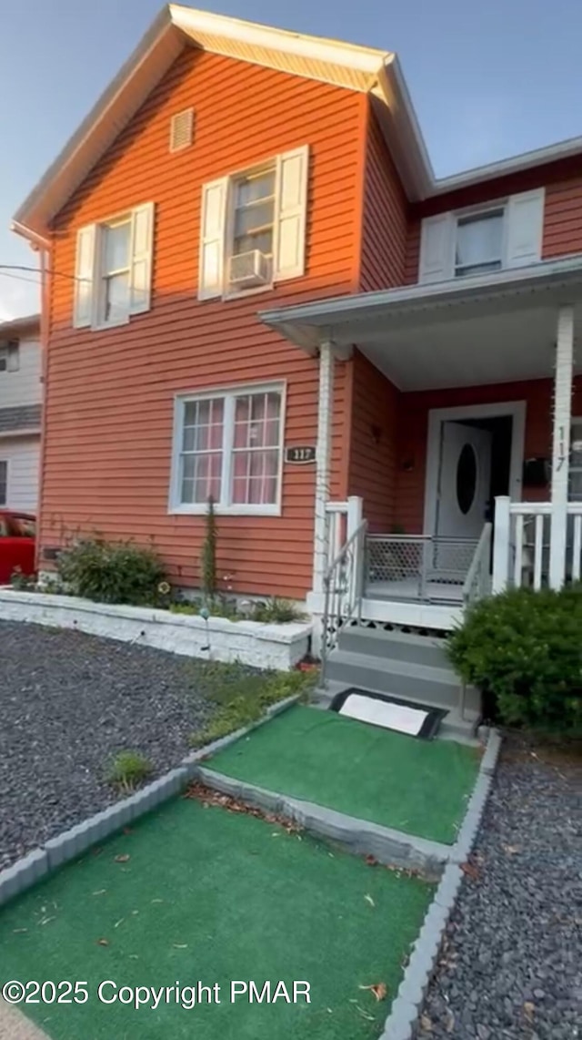 exterior space with a porch and cooling unit