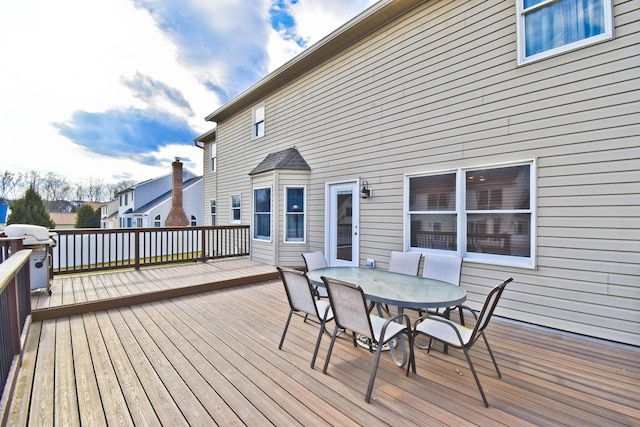 wooden terrace featuring outdoor dining space