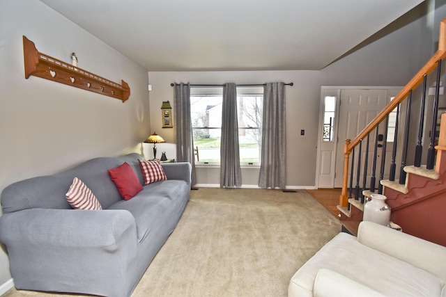living area with stairs, carpet, and baseboards