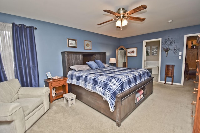 bedroom featuring carpet, ensuite bathroom, baseboards, and ceiling fan