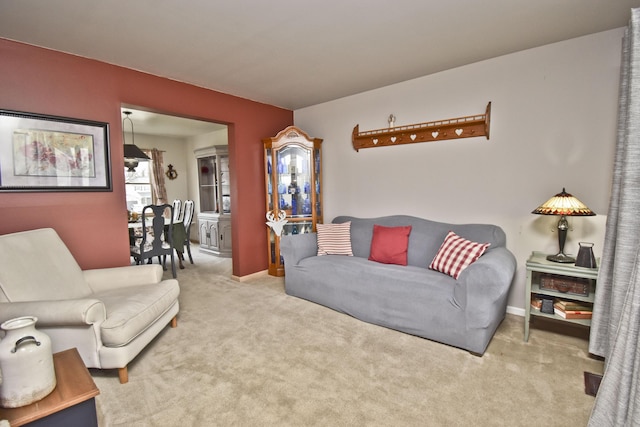 carpeted living room with baseboards