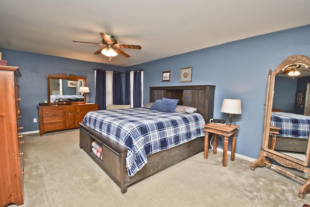 carpeted bedroom featuring baseboards and a ceiling fan