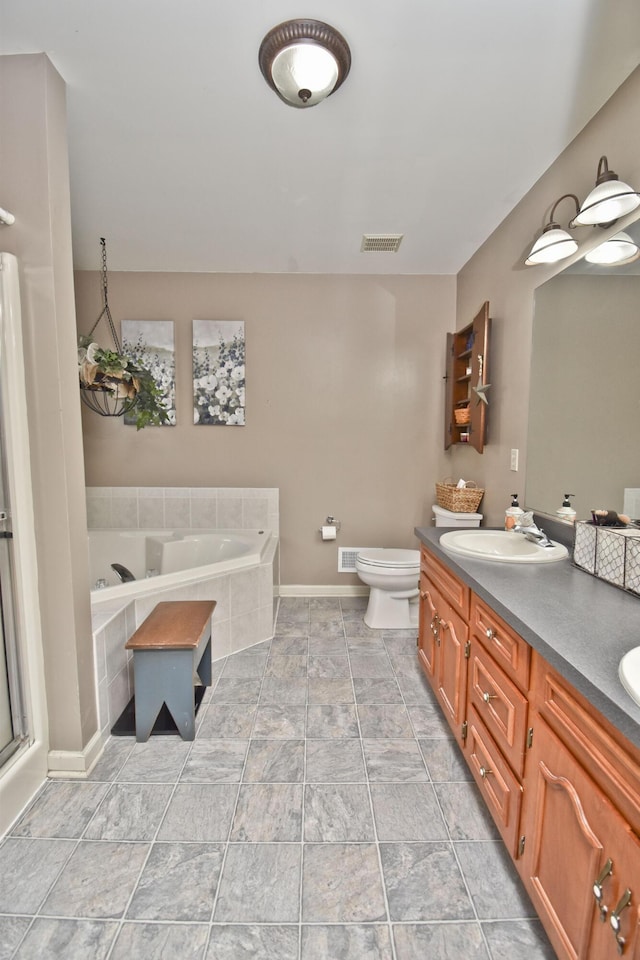 bathroom featuring toilet, visible vents, a bath, a sink, and double vanity