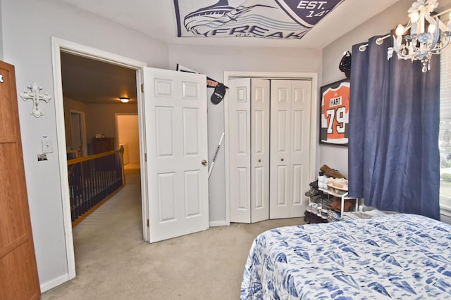 carpeted bedroom with a closet and a chandelier