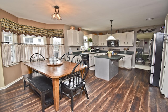 dining space featuring plenty of natural light, dark wood-style flooring, and baseboards