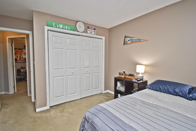 bedroom featuring carpet, a closet, and baseboards