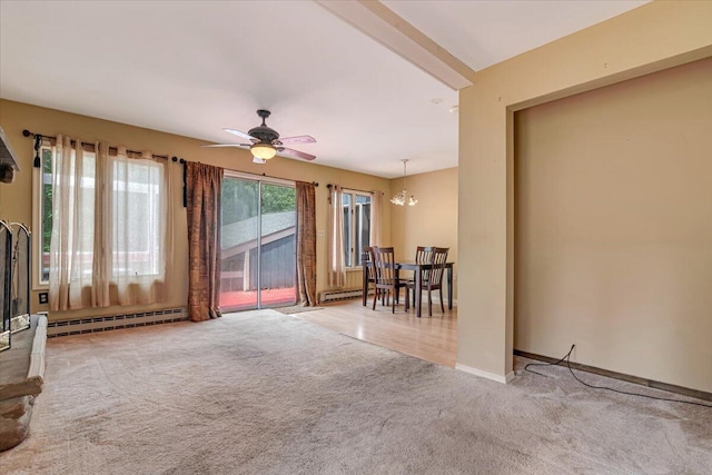 250 Sunrise Loop, Henryville, PA 18332 - carpeted living room with baseboard heating, a chandelier, a ceiling fan, and a baseboard radiator