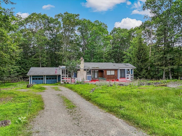 250 Sunrise Loop, Henryville, PA 18332 - ranch-style home with driveway, covered porch, a chimney, a garage, and a forest view