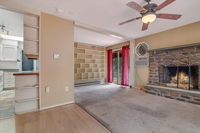 250 Sunrise Loop, Henryville, PA 18332 - unfurnished living room with a stone fireplace, baseboard heating, a ceiling fan, built in features, and carpet