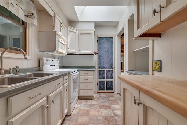 250 Sunrise Loop, Henryville, PA 18332 - kitchen with white appliances, stone finish floors, and a skylight