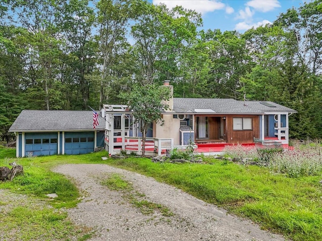 250 Sunrise Loop, Henryville, PA 18332 - view of front facade with driveway, a garage, a chimney, and a porch