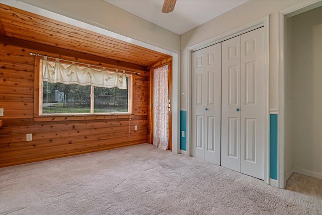 250 Sunrise Loop, Henryville, PA 18332 - unfurnished bedroom featuring carpet floors, wooden walls, a closet, and a ceiling fan