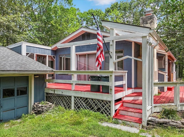 250 Sunrise Loop, Henryville, PA 18332 - rear view of house featuring a chimney, a shingled roof, a sunroom, and a wooden deck