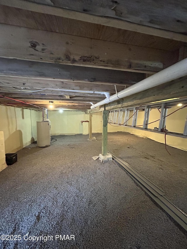 unfinished basement featuring water heater