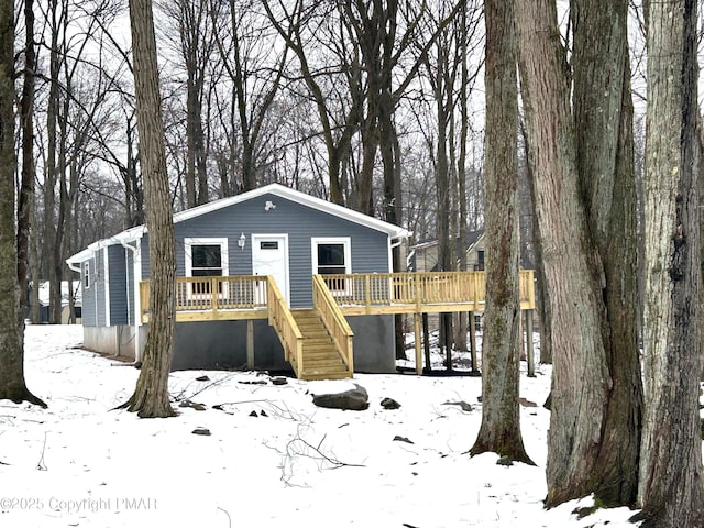 view of front of house featuring stairs and a wooden deck
