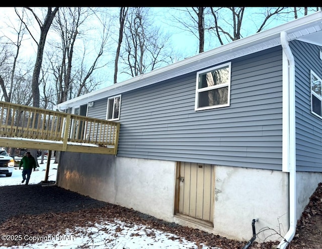 view of snow covered exterior featuring a deck