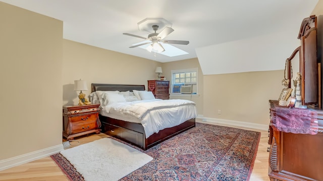 141 Old River Rd, Thornhurst, PA 18424 - bedroom with light wood-type flooring, baseboards, vaulted ceiling with skylight, cooling unit, and ceiling fan