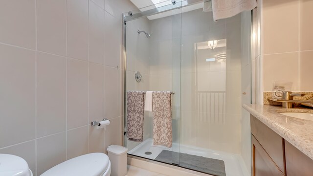 141 Old River Rd, Thornhurst, PA 18424 - full bathroom featuring toilet, a stall shower, vanity, and tile walls