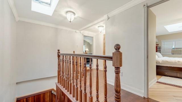 141 Old River Rd, Thornhurst, PA 18424 - corridor featuring ornamental molding, a skylight, wood finished floors, an upstairs landing, and baseboards