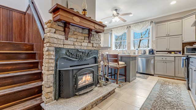 141 Old River Rd, Thornhurst, PA 18424 - kitchen with light tile patterned floors, a ceiling fan, a warm lit fireplace, dishwasher, and light countertops