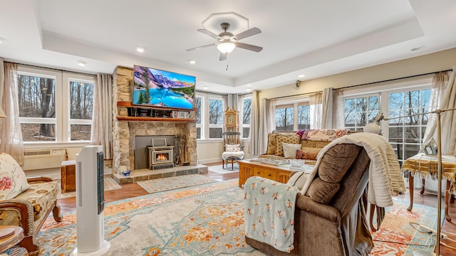141 Old River Rd, Thornhurst, PA 18424 - living area with a raised ceiling, wood finished floors, a fireplace, and a ceiling fan