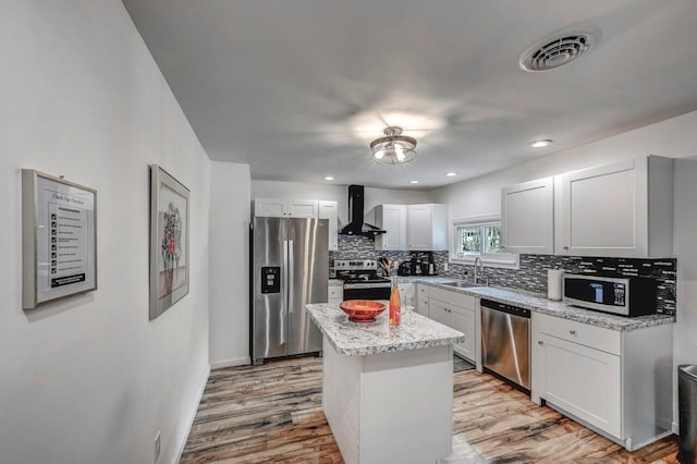 134 Altemose Rd, Pocono Lake, PA 18347 - kitchen with visible vents, light wood-style floors, wall chimney exhaust hood, a sink, and appliances with stainless steel finishes