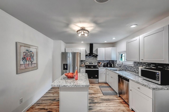 134 Altemose Rd, Pocono Lake, PA 18347 - kitchen featuring wall chimney range hood, decorative backsplash, a sink, stainless steel appliances, and light wood-style flooring