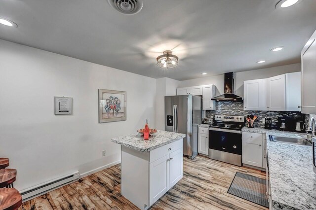 134 Altemose Rd, Pocono Lake, PA 18347 - kitchen featuring a sink, wall chimney range hood, a baseboard radiator, light wood finished floors, and stainless steel appliances