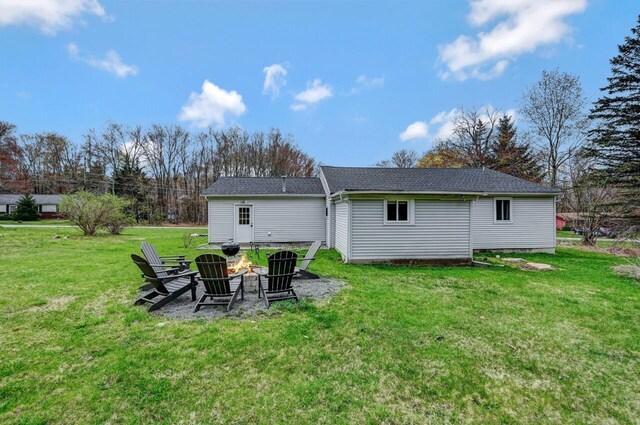 134 Altemose Rd, Pocono Lake, PA 18347 - rear view of property with a lawn, a shingled roof, and an outdoor fire pit